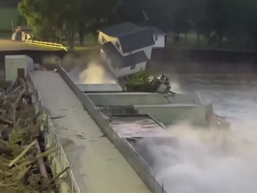 Family watches as house falls into Blue Earth River