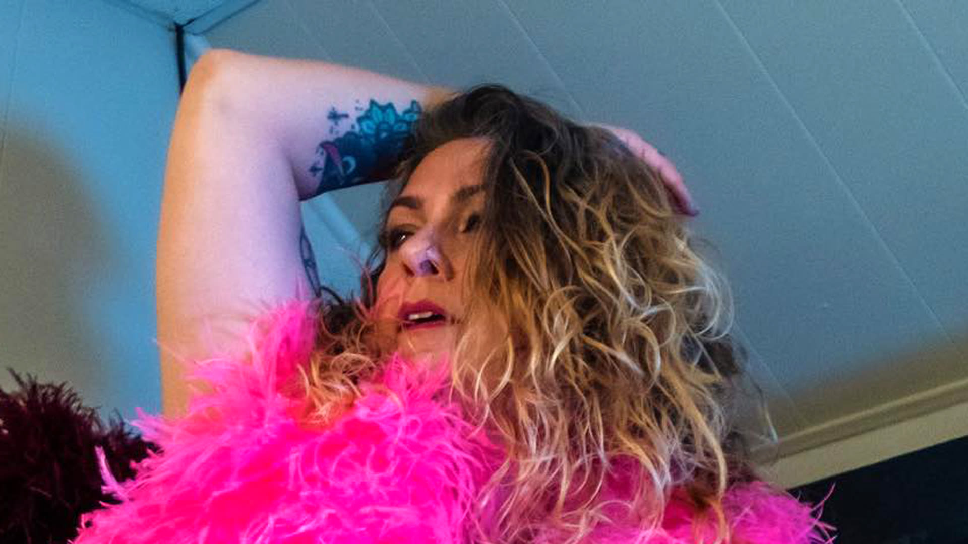 American Pickers' Danielle Colby covers naked body in a neon feather boa