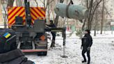 Ukrainian emergency workers dispose of unexploded warhead of Russian missile in Kyiv