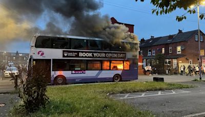 Watch thugs set bus on FIRE using cigarette lighters in shocking riot vid