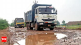 Back-breaking ride: Road filled with craters, trucks making them worse | Ghaziabad News - Times of India