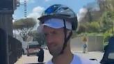 Novak Djokovic wears cycle helmet to sign autographs after water bottle incident