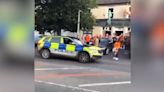 Police celebrate Armagh All-Ireland win with laps of the road waving flags