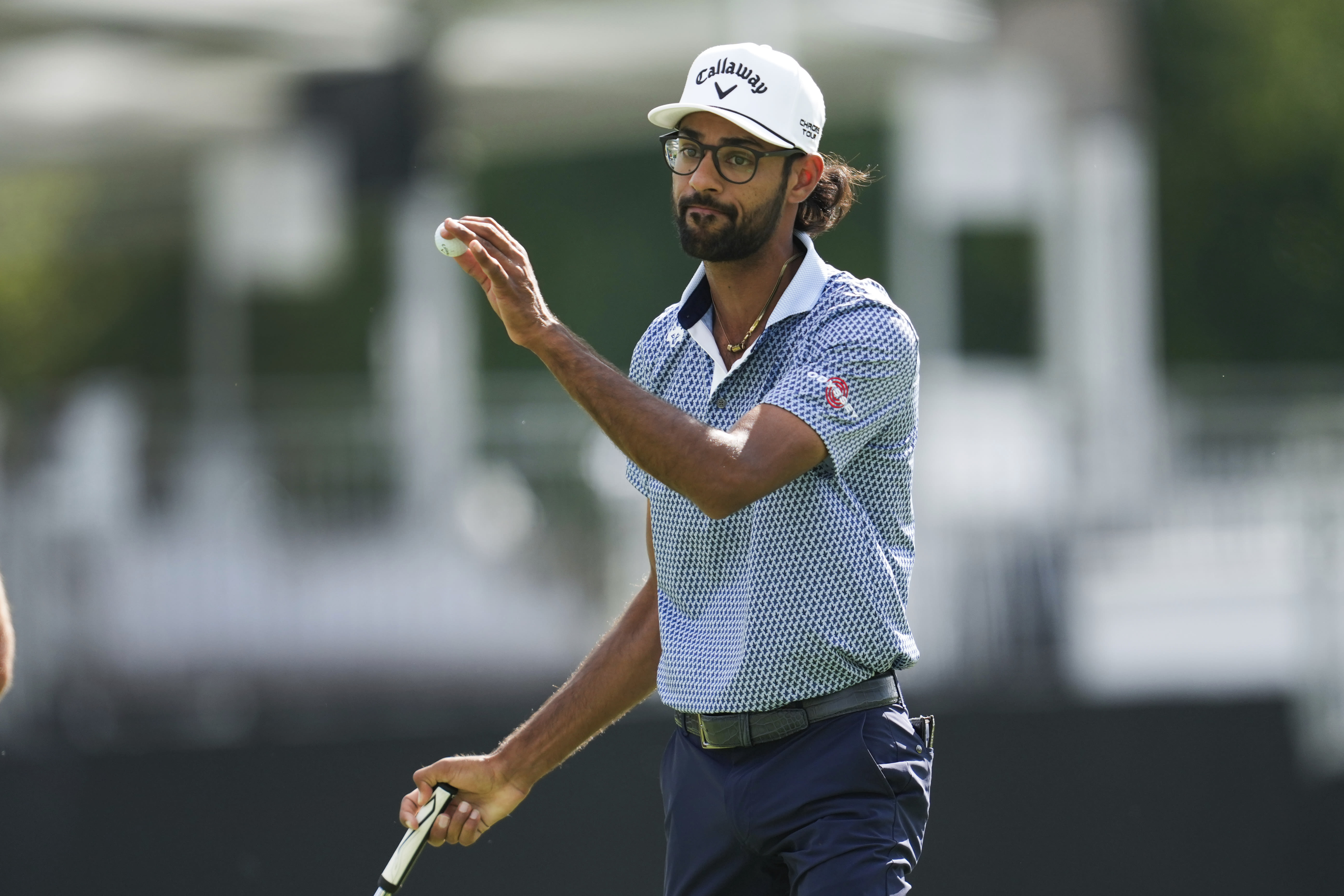 Akshay Bhatia's golf ball falls into a fairway drain, leading to an unusual free drop