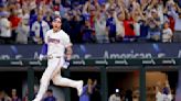 World champion Rangers overcome disputed tip and beat Cubs 4-3 on Heim's 10th-inning single