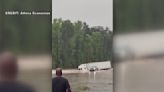 When all you see is truck top, it's time to go! Game Wardens helping families evacuate floodwaters