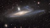 Dark Energy Camera captures galaxy being slowly swallowed by its neighbor