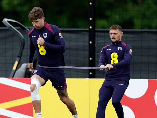 Stones pictured wearing knee strapping during England training session