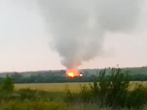 Ukrainian drone assault sets Russian munitions depot on fire