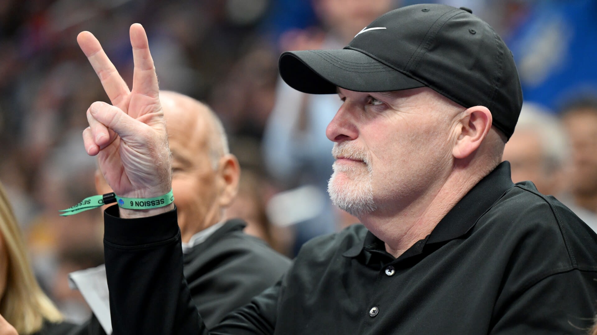 Dan Quinn sports T-shirt incorporating portion of abandoned logo