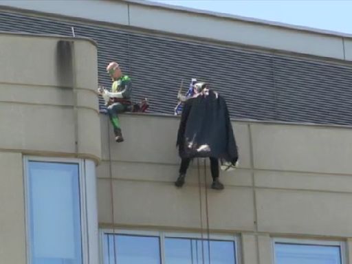 Patients at OSF Children’s Hospital of Illinois watch superheroes wash building’s windows