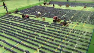 Students, food bank in Battlefords attempt world record mac and cheese box domino topple