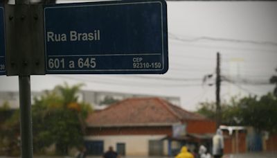 Porta de entrada para bairros alagados de Canoas (RS), Rua Brasil vive rotina de saques e resgates
