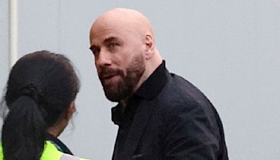 John Travolta arrives at Sydney Airport with family ahead of flight