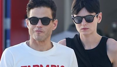 Emma Corrin puts an arm round fiancé Rami Malek after outing in WeHo
