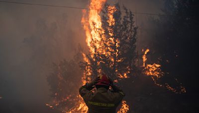 Hundreds of firefighters battle out-of-control forest fire near Athens