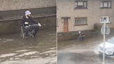 Man spotted fishing in flooded Scots town amid miserable summer storm