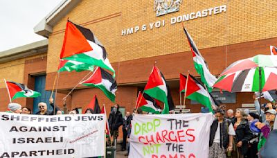 Protesters gather outside prison holding pro-Palestine activist