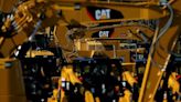 Caterpillar profit slides as costs and forex squeeze margins, shares down