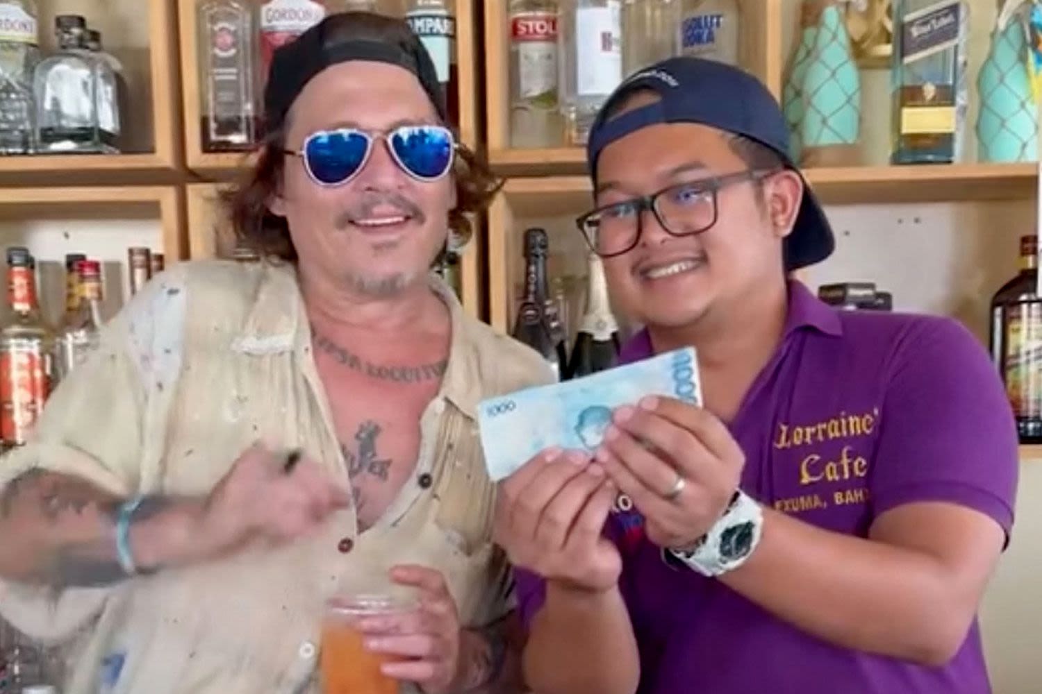 Johnny Depp Happily Samples a Drink Behind the Bar While Visiting a Restaurant in the Bahamas