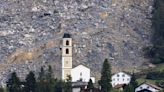 Mass of rock slides down Swiss mountainside above evacuated village, narrowly missing settlement