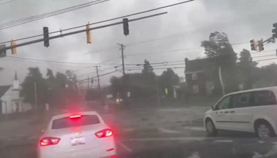 Cars drive through funnel cloud as tornado whips up debris in Maryland