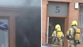Clouds of dark smoke pour out of window as 999 crews race to tenement fire