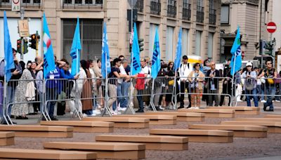 Mock coffins fill a square in Milan in a protest over workplace safety in Italy