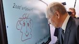 Watch Putin draw a weird face on a smart board as Russia tries to act like everything is normal after Wagner went rogue