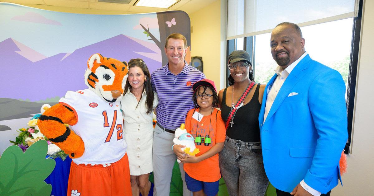 Extending a paw: Coach Dabo Swinney helps deliver My Special Aflac Duck® to children ahead of the Aflac Kickoff Game