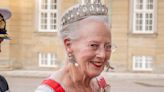 Queen Margrethe of Denmark’s flamingo-pink patterned gown with flattering waist belt proves the royal color of the season isn’t going anywhere