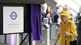 Queen beams in sunshine yellow for surprise visit to open Elizabeth line