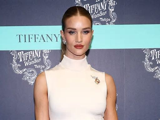 Rosie Huntington-Whiteley is the epitome of chic in a sleeveless white gown as she attends Tiffany & Co exhibition launch in Tokyo