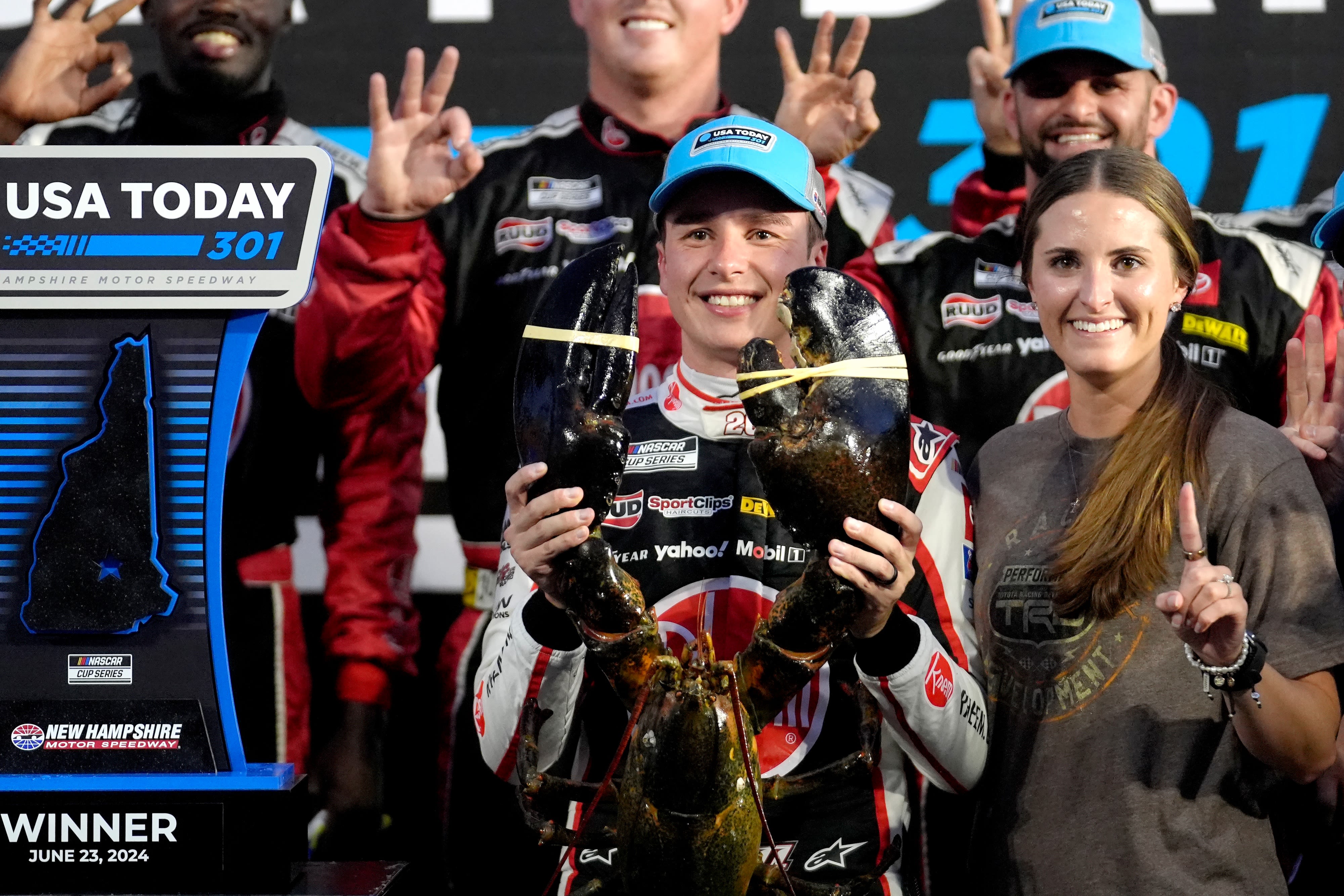 Christopher Bell takes the checkered flag on rain tires in the NASCAR Cup race at New Hampshire