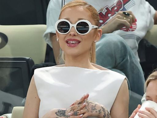 Ariana Grande Embraces 1960s Styling in White Boatneck Dress and Statement Sunglasses at 2024 Paris Olympics with Cynthia Erivo and Baz Luhrmann