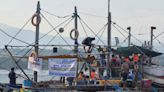 About 100 Filipino activists and fishermen sail on wooden boats to disputed shoal guarded by China