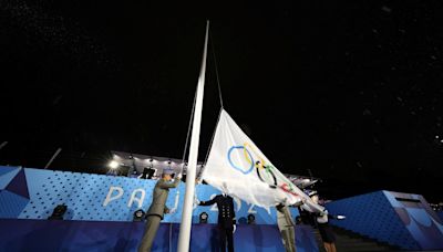 Olympic flag raised upside down at end of rain-soaked opening ceremony
