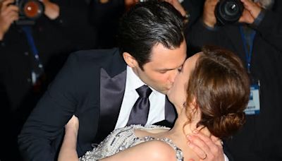 Penn Badgley passionately kisses Charlotte Ritchie on the red carpet as they film a steamy scene for the fifth and FINAL season of You