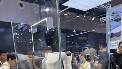 Tesla shows its humanoid robot Optimus at China AI conference, but behind glass