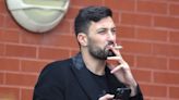 Giovanni Pernice looks downcast as he smokes a cigarette