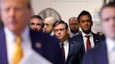 ...Mike Johnson and former presidential candidate Vivek Ramaswamy listen as former President Donald Trump speaks to reporters as he arrives for his trial for allegedly covering up hush money payments linked to extramarital...