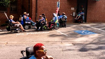 Disability rights activists block DHHS doors during Raleigh protest, risking arrest