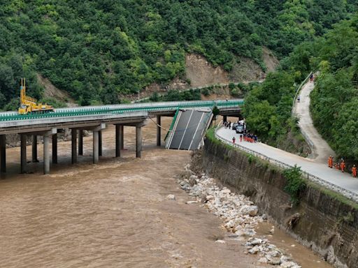 11 dead and dozens missing after a highway bridge in China crumbles in flooding and heavy storms