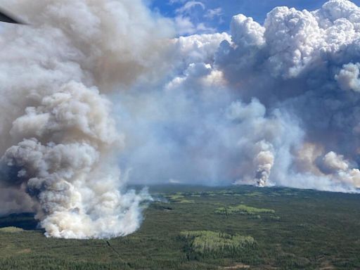 Wildfires encircle Fort McMurray, threatening crude production