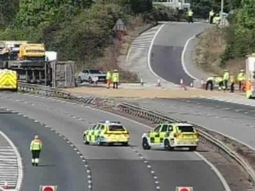 Lorry crashes through central reservation and flips over on M40