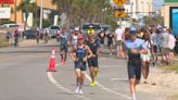 Athletes cross the finish line at IRONMAN 70.3 Gulf Coast