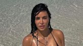 Kim baffles fans as she dives in 'knee-deep water' for new bikini photos