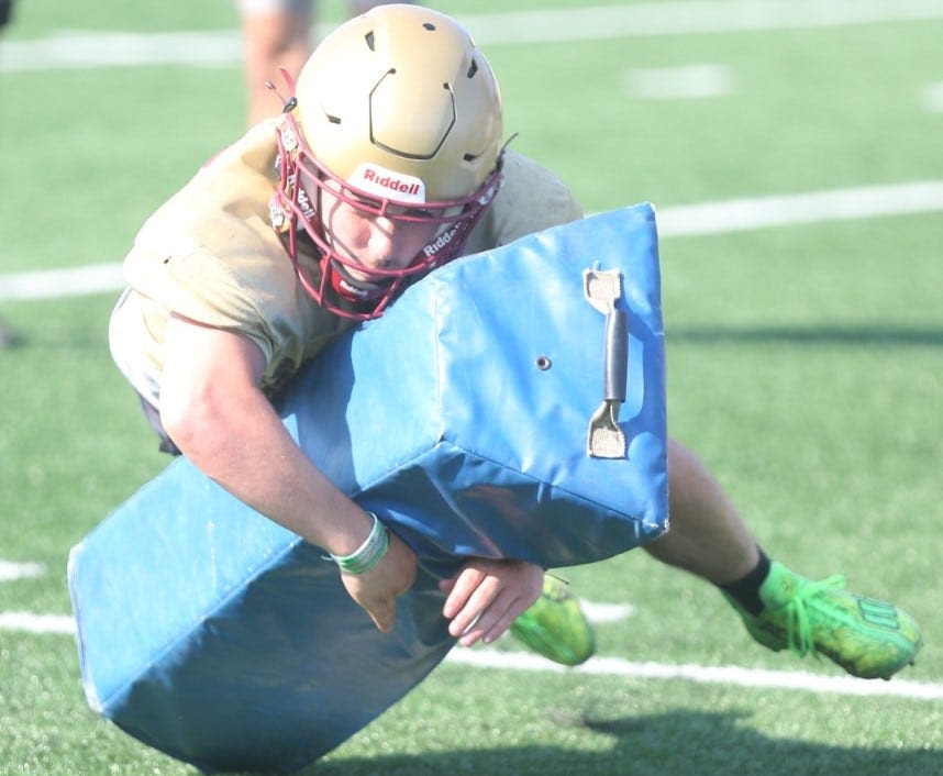 Dover coach prepares Team East for CHaD football game; Dover, Portsmouth have 5 players