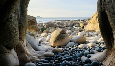 The secluded beach with 'dinosaur egg' boulders and historic submarine wreck