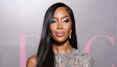 Naomi Campbell disguises mystery bandages beneath rippling slip dress during runway show